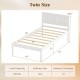 Twin size wooden platform bed frame in white with headboard, featuring plywood slats and elevated design for storage.