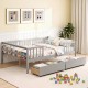 Full size gray daybed with fence and two pull-out drawers, perfect for children's storage and safety in a cozy room.