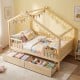 House-shaped full-size bed with fence rails, natural wood, and two large storage drawers for kids' toys and blankets.