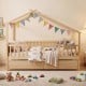 House-shaped full-size bed with fence rails and storage drawers, made of solid wood for kids' imaginative play.