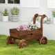 Decorative wooden wagon cart in rustic brown with flowers, featuring wheels, handle, and drainage hole for garden use.