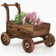 Decorative wooden wagon cart in rustic brown, featuring a flower display, sturdy wheels, and drainage hole for garden.