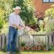 Mini greenhouse with roll-up zipper door, sturdy metal frame, and PE cover, ideal for protecting plants in any season.