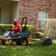 Metal lawn roller in black being towed by a tractor, designed for yard and garden use, with a 17-gallon capacity.