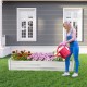 Metal galvanized raised garden bed with open-ended base, ideal for flowers and vegetables, shown in a garden setting.