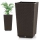 Brown wicker flower pot with drainage hole, ideal for outdoor use, featuring self-watering disk for optimal plant care.