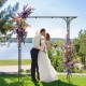 Metal garden arch with floral decorations, perfect for supporting climbing plants and enhancing garden entryways.