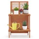 Folding garden potting bench with teak oil finish, featuring 2-tier storage for plants and tools, ideal for outdoor use.