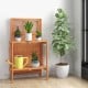 Folding garden potting bench showcasing a slatted design and teak oil finish, perfect for organizing plants on a.