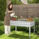Galvanized raised garden bed with legs, featuring vibrant flowers and drainage holes for healthy plant growth.