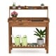 Outdoor wooden garden table work station with sink, storage drawer, and shelves for organized gardening tasks.