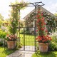 Garden arbor with gate and planter boxes, showcasing decorative patterns and a stable triangular structure for gardens.