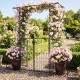 Garden arbor with gate and planter boxes, featuring a heavy-duty metal arch and side trellis for climbing plants.