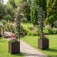 Garden arch trellis with two self-watering planter boxes in black, perfect for supporting climbing plants in your yard.