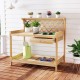 Wooden garden potting bench with lattice trellis, spacious countertop, and slide-out drawer for plant storage.