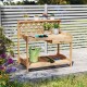 Wooden garden potting bench with lattice trellis, spacious countertop, and slide-out drawer for storage in outdoor.