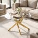 Round glass coffee table with a golden geometric metal frame, featuring a tempered glass top for modern living spaces.