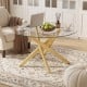 Round glass coffee table with a geometric gold metal frame, perfect for modern living spaces and easy maintenance.