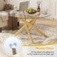 Round glass coffee table with a tempered glass top and geometric gold metal frame, perfect for modern living spaces.