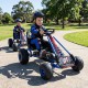 Kids riding blue go karts with adjustable seats and multi-terrain wheels for outdoor fun and safety.