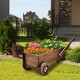 Wooden wagon planter box with wheels, featuring vibrant flowers, perfect for outdoor decoration and plant display.