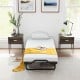 Twin size folding bed with a 4-inch foam mattress, featuring anti-slip foot pads and a cozy yellow throw for added.