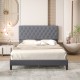 Gray upholstered platform bed with button tufted headboard and sturdy wooden slats, perfect for stylish bedroom decor.