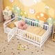 Twin size floor bed in white with high fence and door, designed for kids' safety and playful independence.