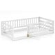 Twin size floor bed in white with high fence and door, crafted from sturdy pine wood for kids' safety and play.