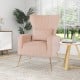 Elegant pink velvet wingback chair with a spacious seating area and golden metal legs, ideal for stylish relaxation.