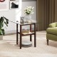 Square glass coffee table with brown rubber wood legs, featuring a storage shelf for versatile home use.