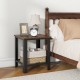 Industrial end table in black with a wood top and lower netlike shelf, perfect as a nightstand or side table.