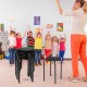 Set of 6 black portable plastic stack stools with sturdy steel frame, ideal for classrooms and easy storage.