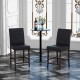Two black bar stools with soft padded seats and espresso finish, perfect for counter height dining in bars or kitchens.