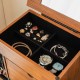 Vintage jewelry storage cabinet with compartments for rings, bracelets, and watches, featuring a top flip mirror.