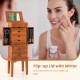 Vintage jewelry storage cabinet with flip-up mirror, featuring large compartments and hooks for organized jewelry.