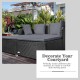 Spacious outdoor rattan daybed with gray upholstered cushions, ideal for creating a comfortable resting space.