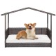 Outdoor wicker dog house with weatherproof roof, featuring a soft cushion and elevated design for comfort and stability.
