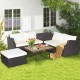 7-piece hand-woven wicker outdoor furniture set with acacia wood coffee table and white cushions for patio relaxation.