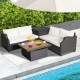 Hand-woven wicker outdoor furniture set with white cushions and acacia wood coffee table, perfect for poolside.