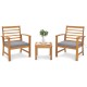 Two acacia wood chairs with gray cushions and a small table, perfect for outdoor relaxation in a backyard setting.