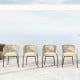 Set of 4 yellow patio chairs with curved backrests and seat cushions, ideal for outdoor relaxation and support.