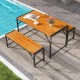 Acacia wood dining table with two benches, sturdy metal frame, perfect for outdoor patios or poolside dining.