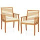 Two outdoor acacia wood armchairs with removable white cushions, perfect for patio dining and bistro conversations.