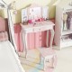 Kids vanity set in pink with tri-fold mirror, storage drawer, and makeup accessories for organized playtime.