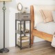 Three-tier tall plant stand in gray with drawer, featuring open shelves for plants and anti-tipping devices for safety.