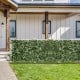 Artificial lily leaf privacy fence in a garden setting, made of durable polyester fabric for year-round vibrancy.