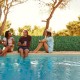 Artificial ivy privacy fence with dense leaves, perfect for outdoor decoration and privacy by the poolside.