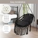 Hanging hammock chair in black with soft cushions, tassels, and sturdy rope chain, ideal for indoor or outdoor use.