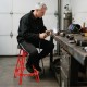 Heavy-duty aluminum garage bar chair in red with a 360° swiveling seat, ideal for workbenches 41"-44" high.